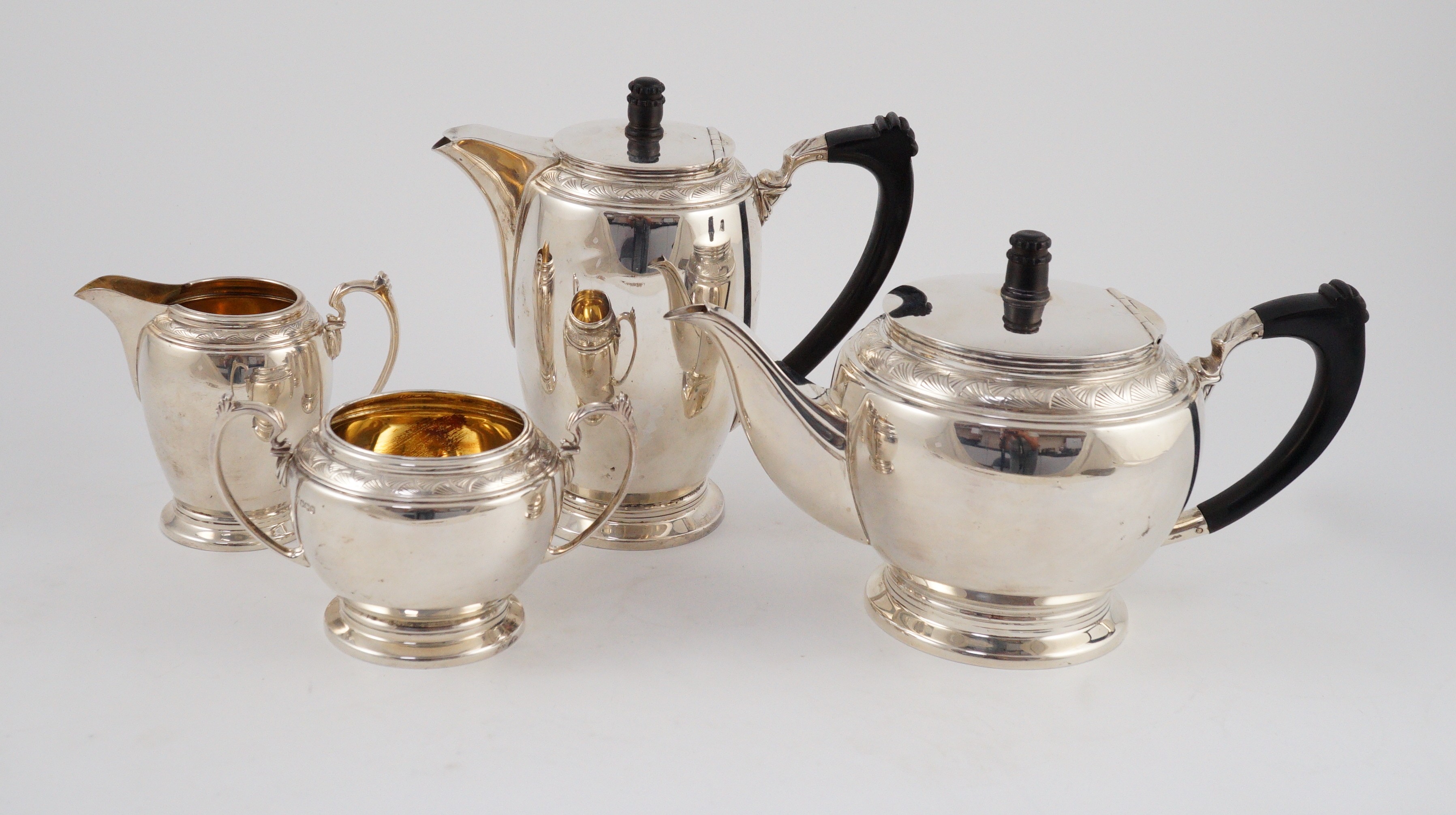 A George VI four piece silver tea set, by Harrods Ltd